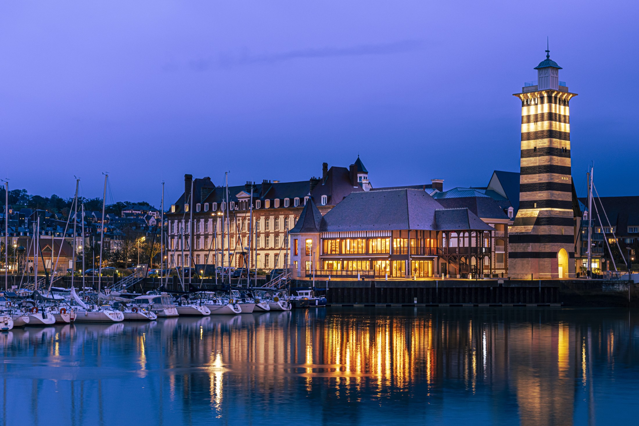Vue nocturne du Meilleur restaurant Deauville trouville, le nouveau restaurant Costes Deauville, avec terrasse illuminée sur le port de plaisance.